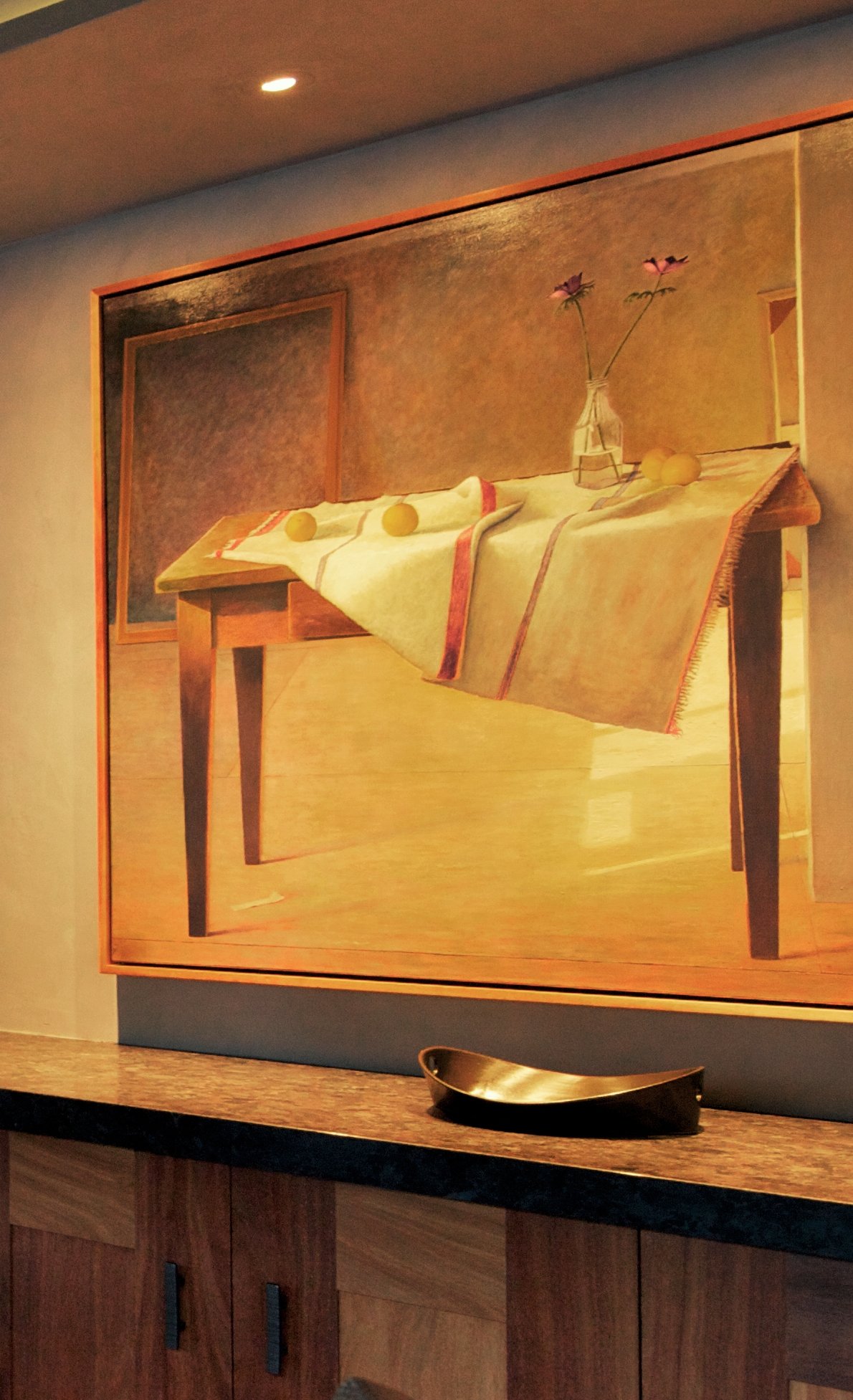 Detail of a framed still-life painting above a walnut credenza