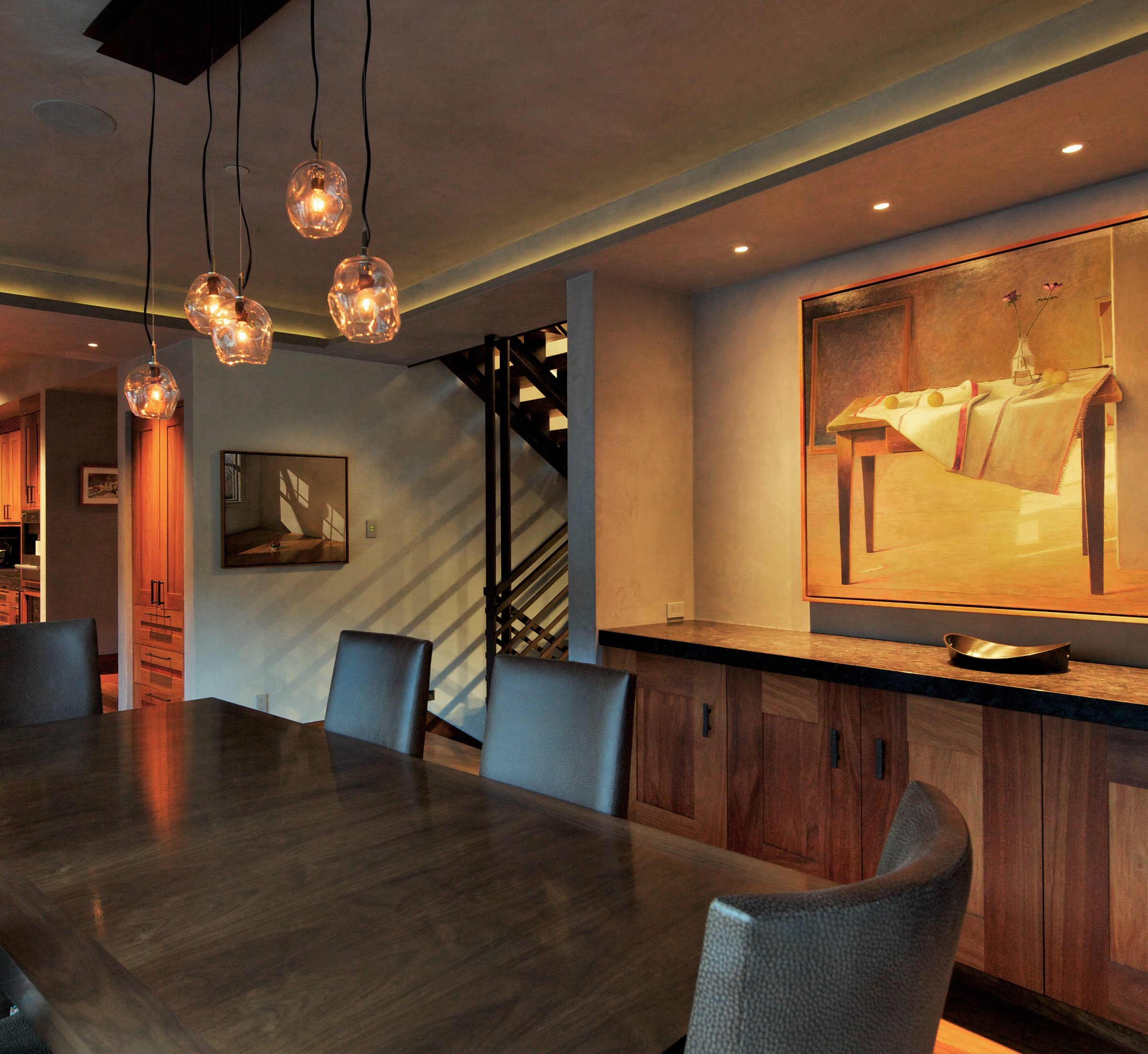 Mike Mohr Freelance Design hero photo — a moody dining room with glass pendant lights and a framed still-life painting
